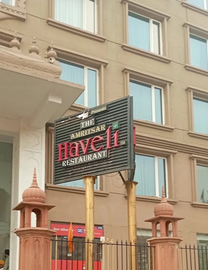 The Amritsar Haveli Restaurant sign next to Saragarhi Sarai